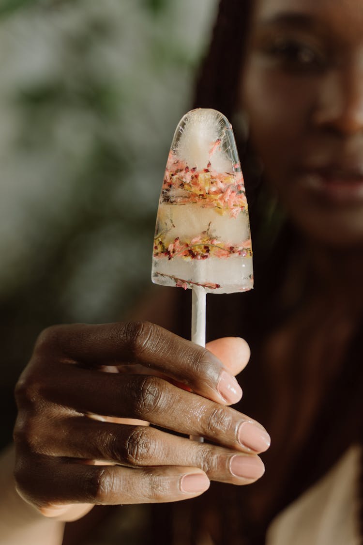 Close Up Shot Of A Woman Holding A Ice Pop