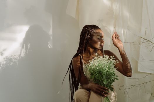 
A Woman Holding a Bouquet of Chamomile Flowers