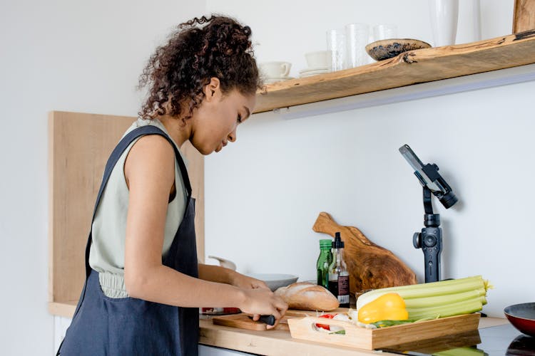 A Woman Filming While Cooking 