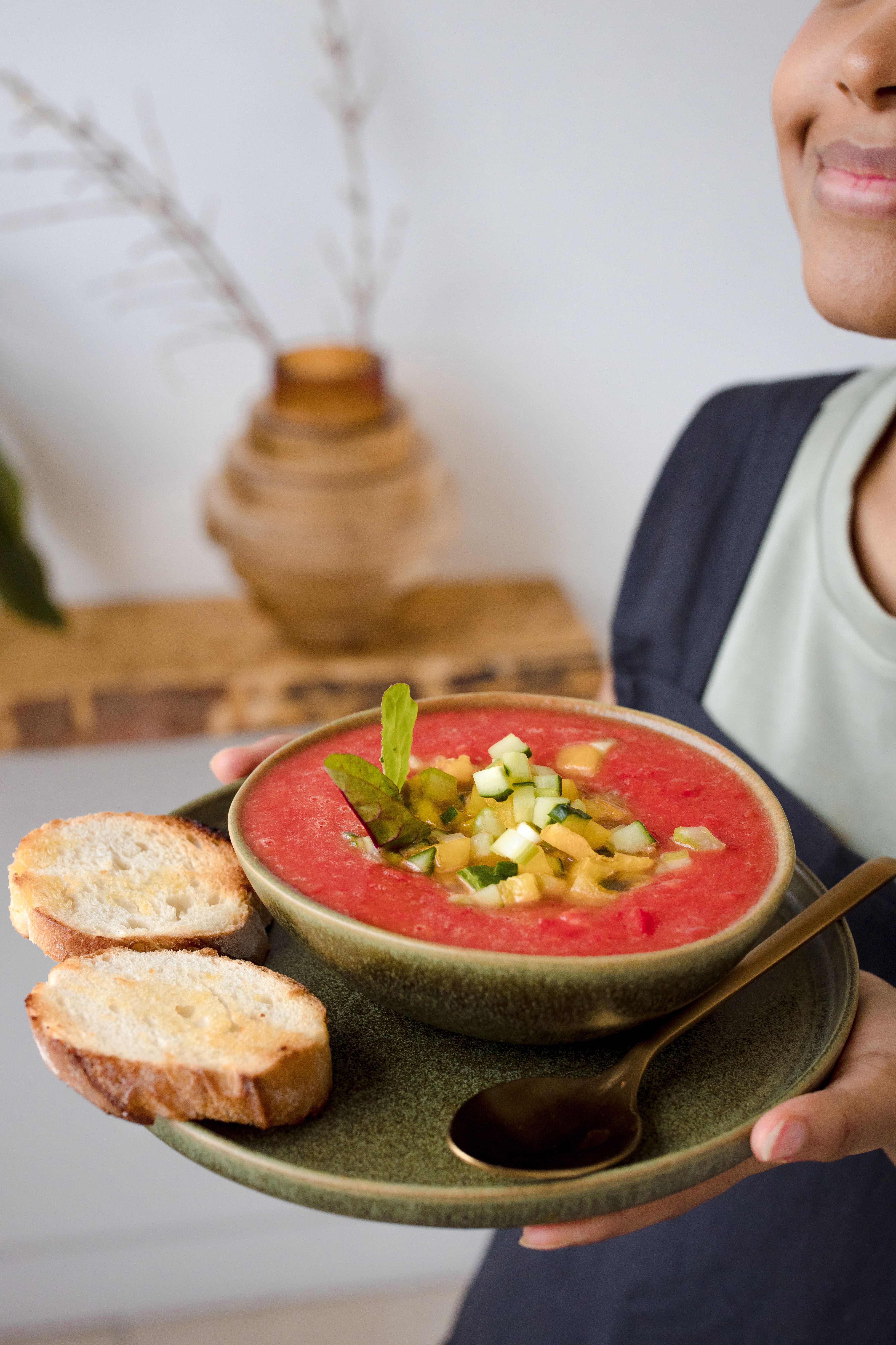 Vibrant gazpacho soup served with toasted bread, perfect for summer meals.