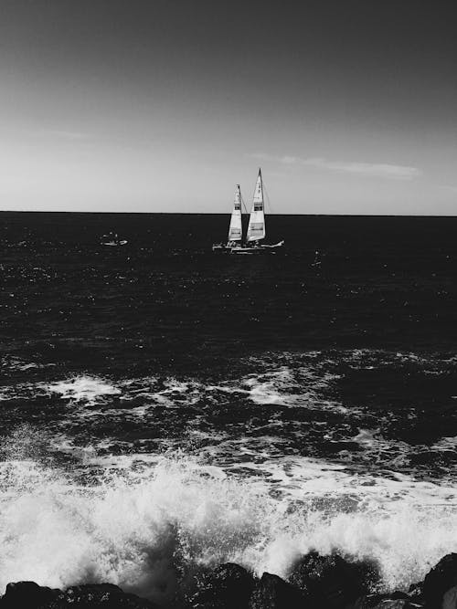 Grayscale Photo of Sailboat on Sea