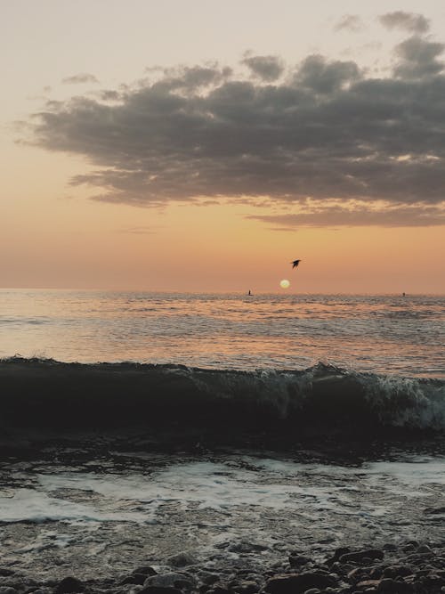 Waves Crashing on a Shore during Sunset