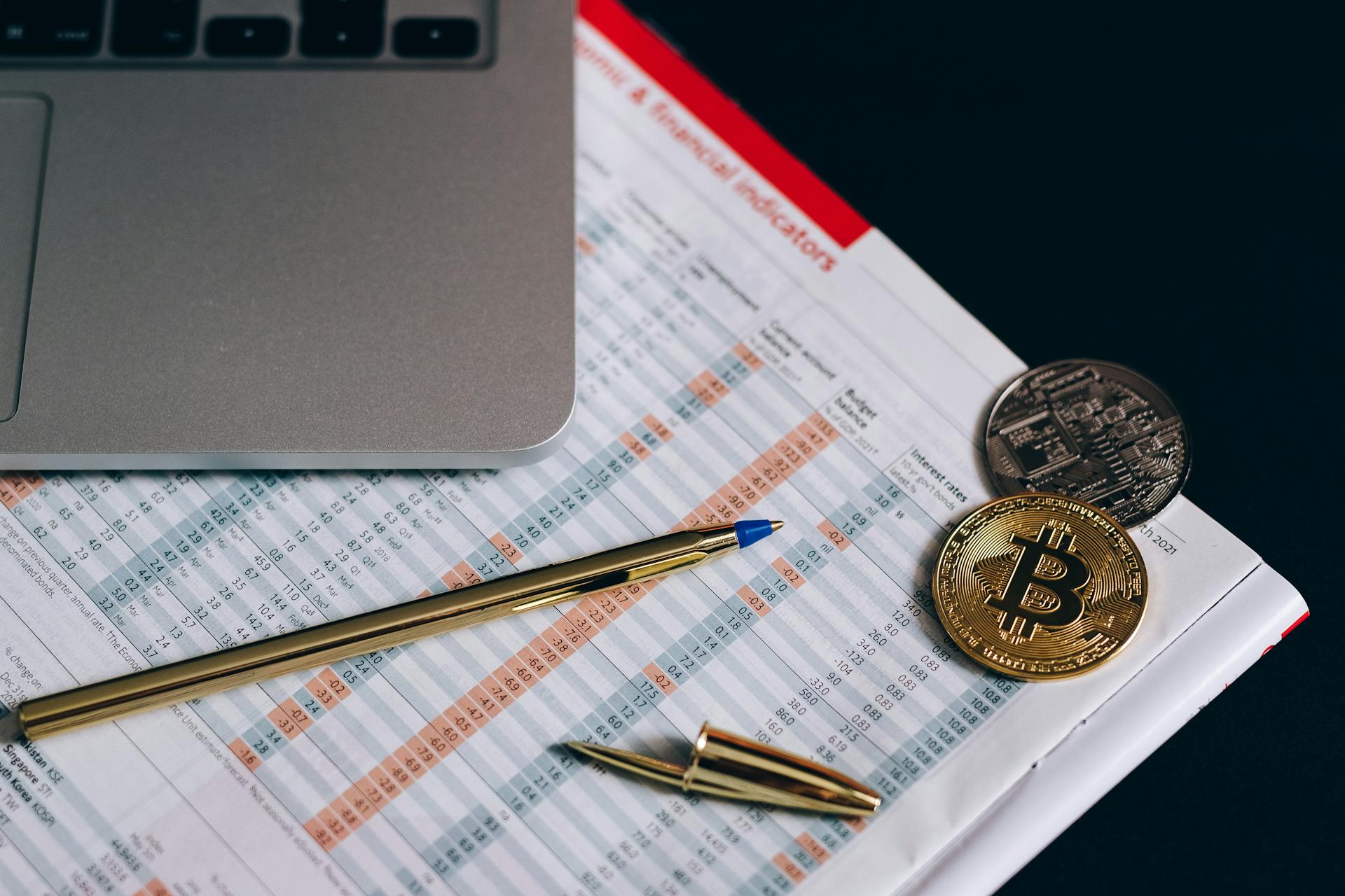 A Bitcoins and Gold Pen on a Paper