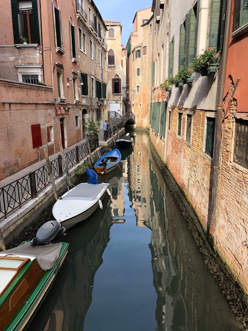 Boats Moored Along a Narrow Venetian Canal