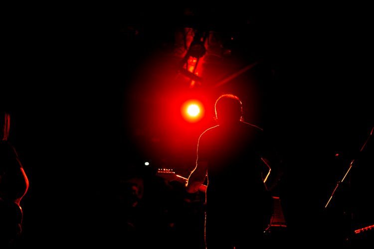 Guitarist Illuminated By A Red Spotlight