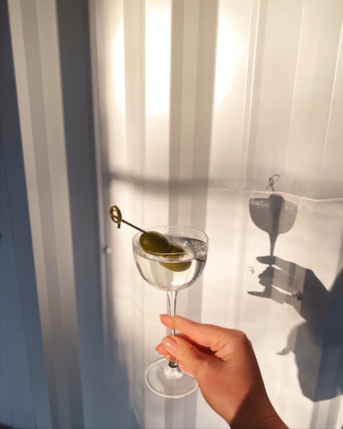 Free Hand Holding a Glass of Martini  Stock Photo
