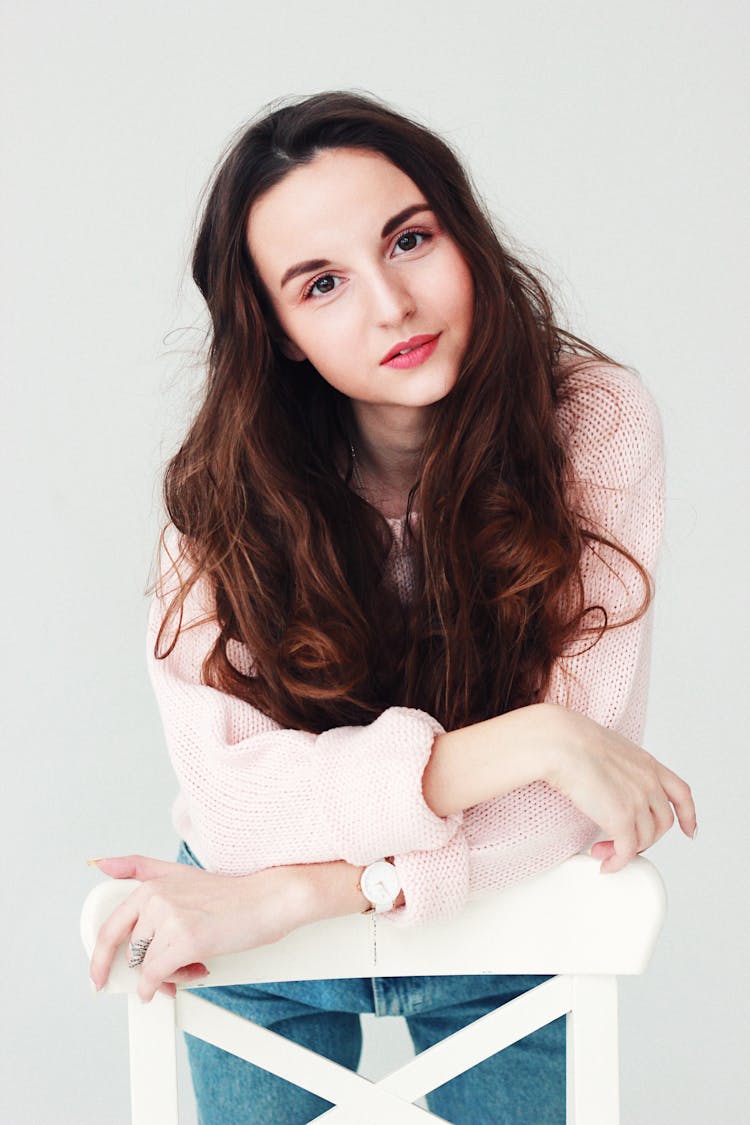 Woman Leaning On White Wooden Chair