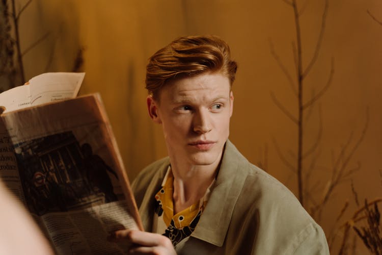 Close-Up Shot Of A Man Holding A Newspaper