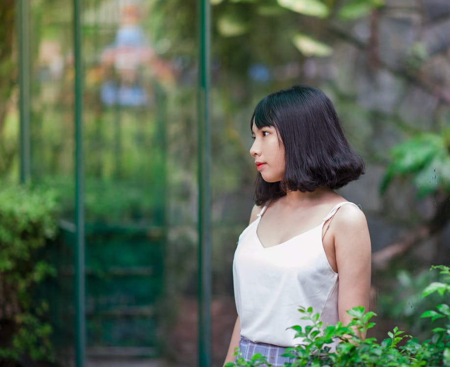 Black Haired Woman in White Spaghetti Strap Top