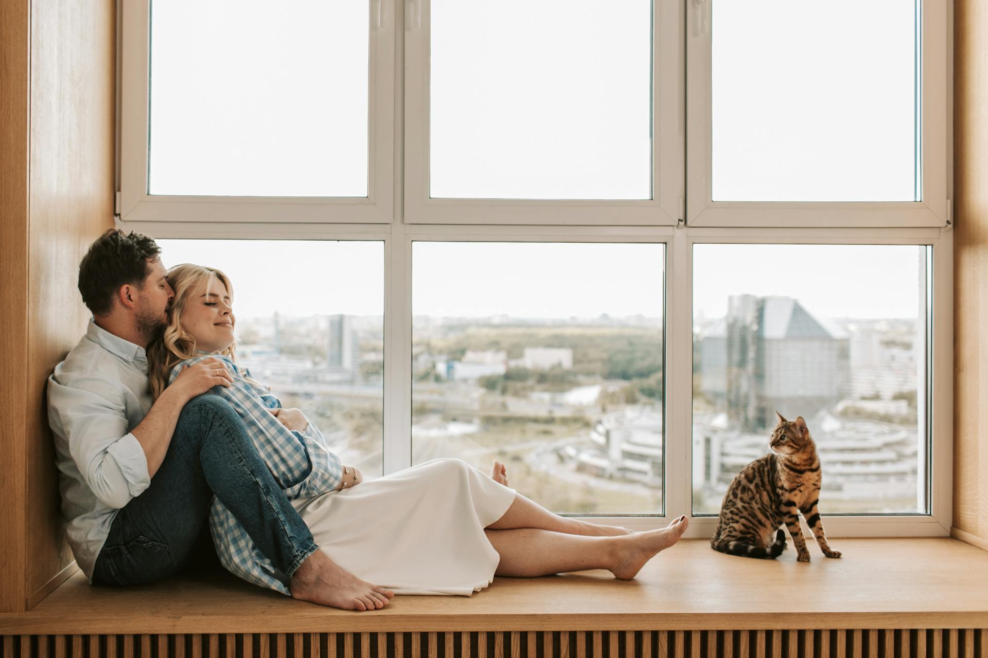 Couple Relaxing and Being Affectionate to Each Other by the Window