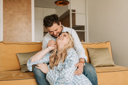 Man and Woman Sitting on Couch