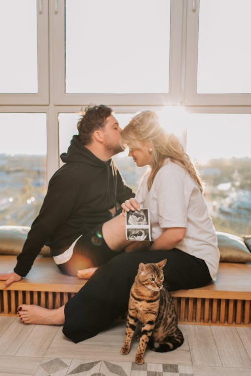 A Man Kissing a Woman on Forehead