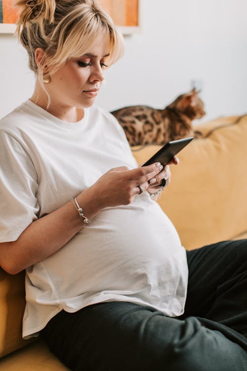 Free Pregnant Woman Using a Tablet Stock Photo