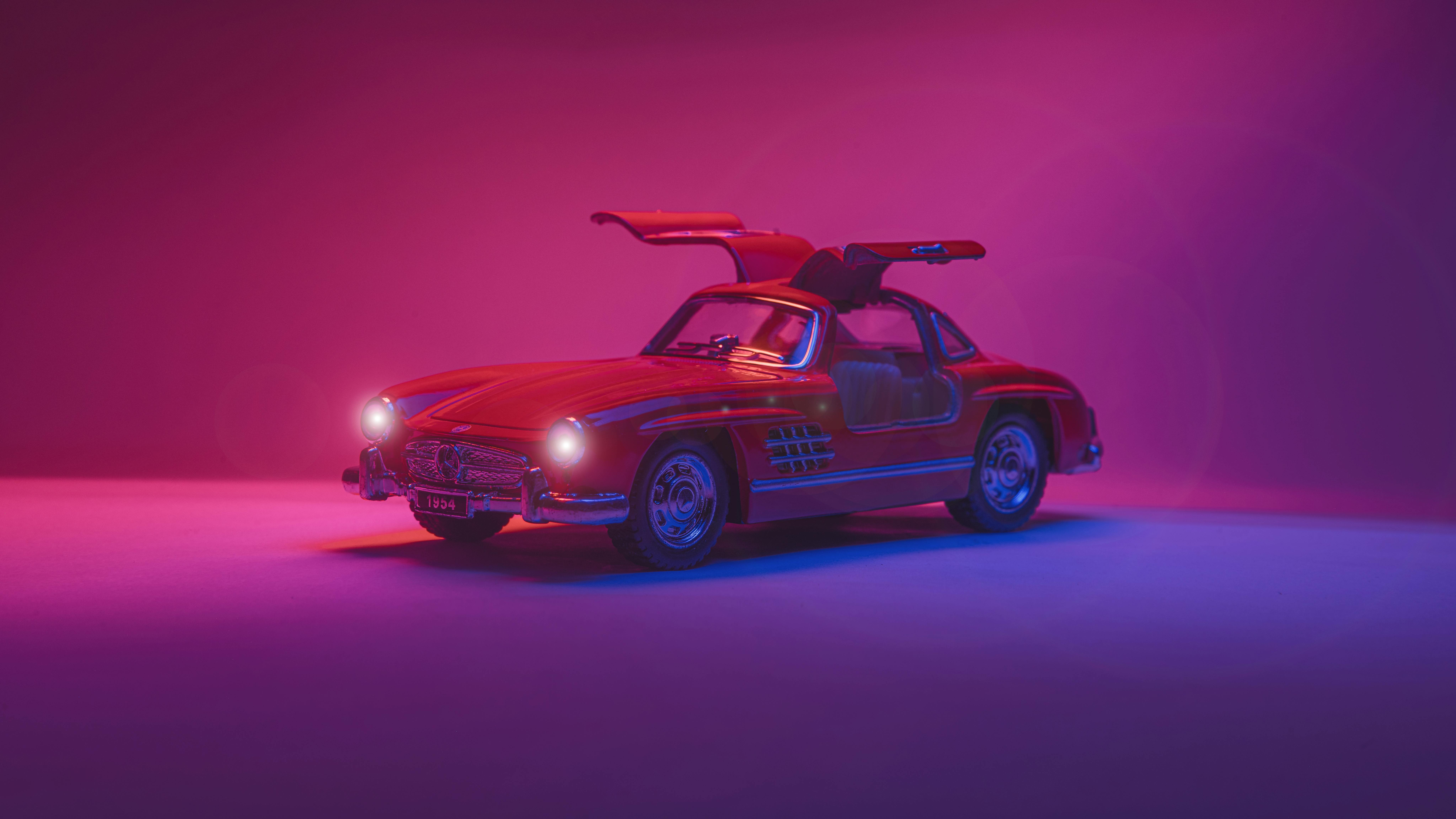 A red luxury electric sports car on display in a studio