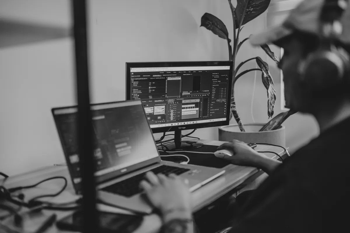 A person working at a desk, comparing human content creation with an automated seo blog writer workflow.