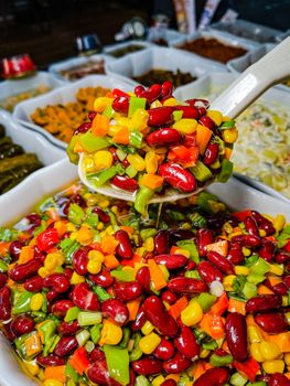 Vibrant mix of vegetables in a spoon, perfect for culinary or market themes.