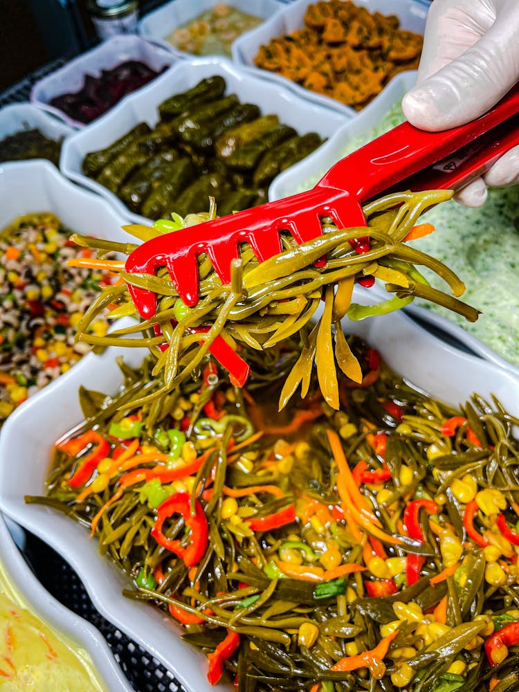 Serving Salad With Plastic Tongs