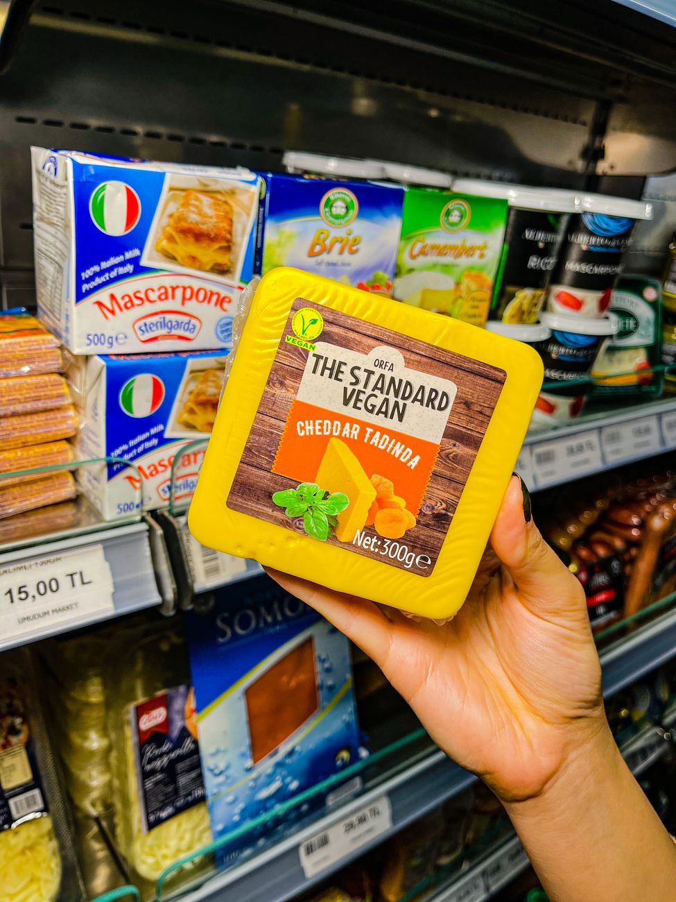 Grocery store shelf with imported cheese and wine on display