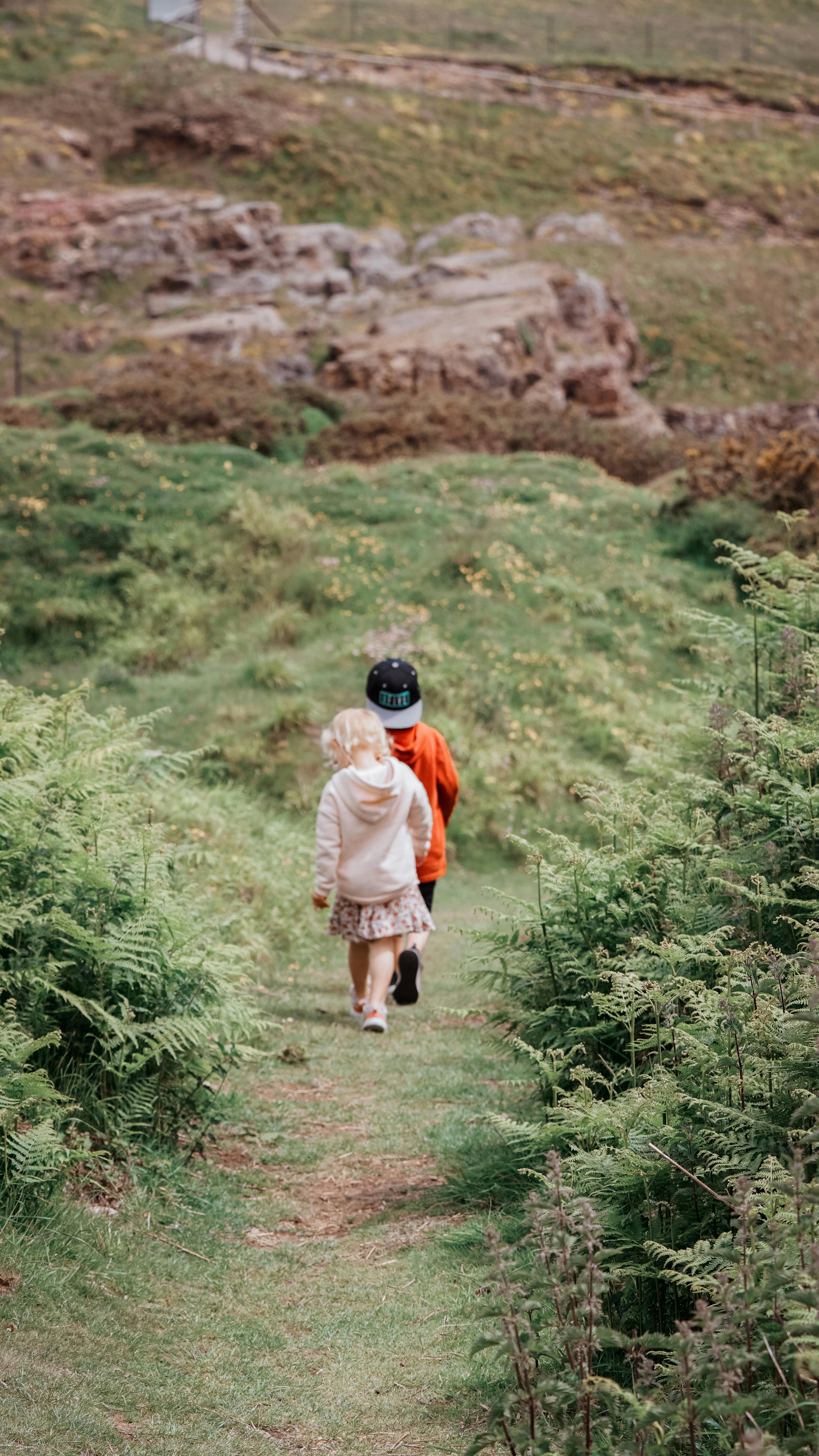 Young children exploring a nature trail in Llandudno, Wales, capturing a moment of outdoor adventure.