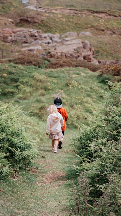 A Children Walking on a Grass