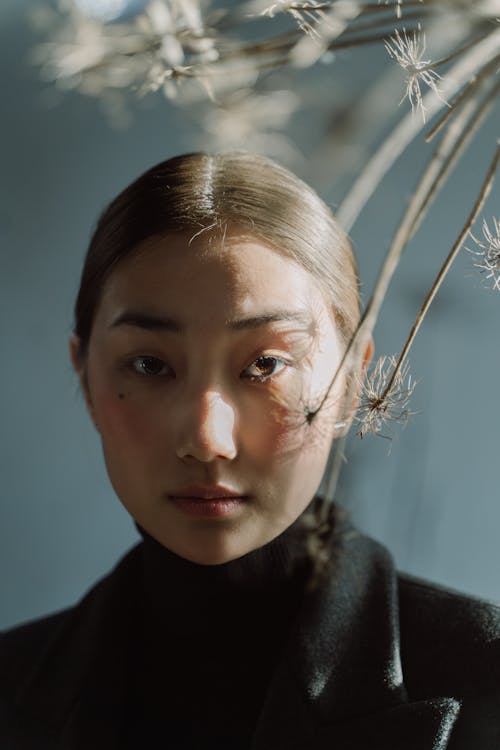 A Woman in Black Turtleneck Shirt Looking with a Serious Face