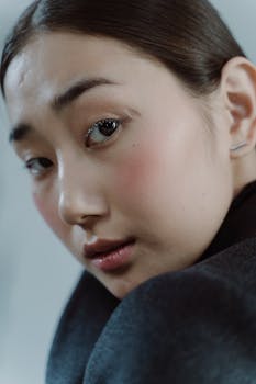 Close-up portrait of a thoughtful woman with a serious expression, perfect for lifestyle or fashion themes.