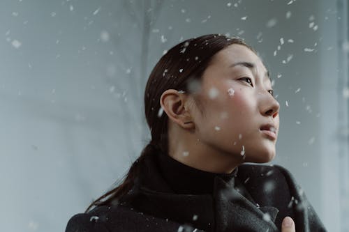 Woman Looking Afar with Snowflakes on her Face 