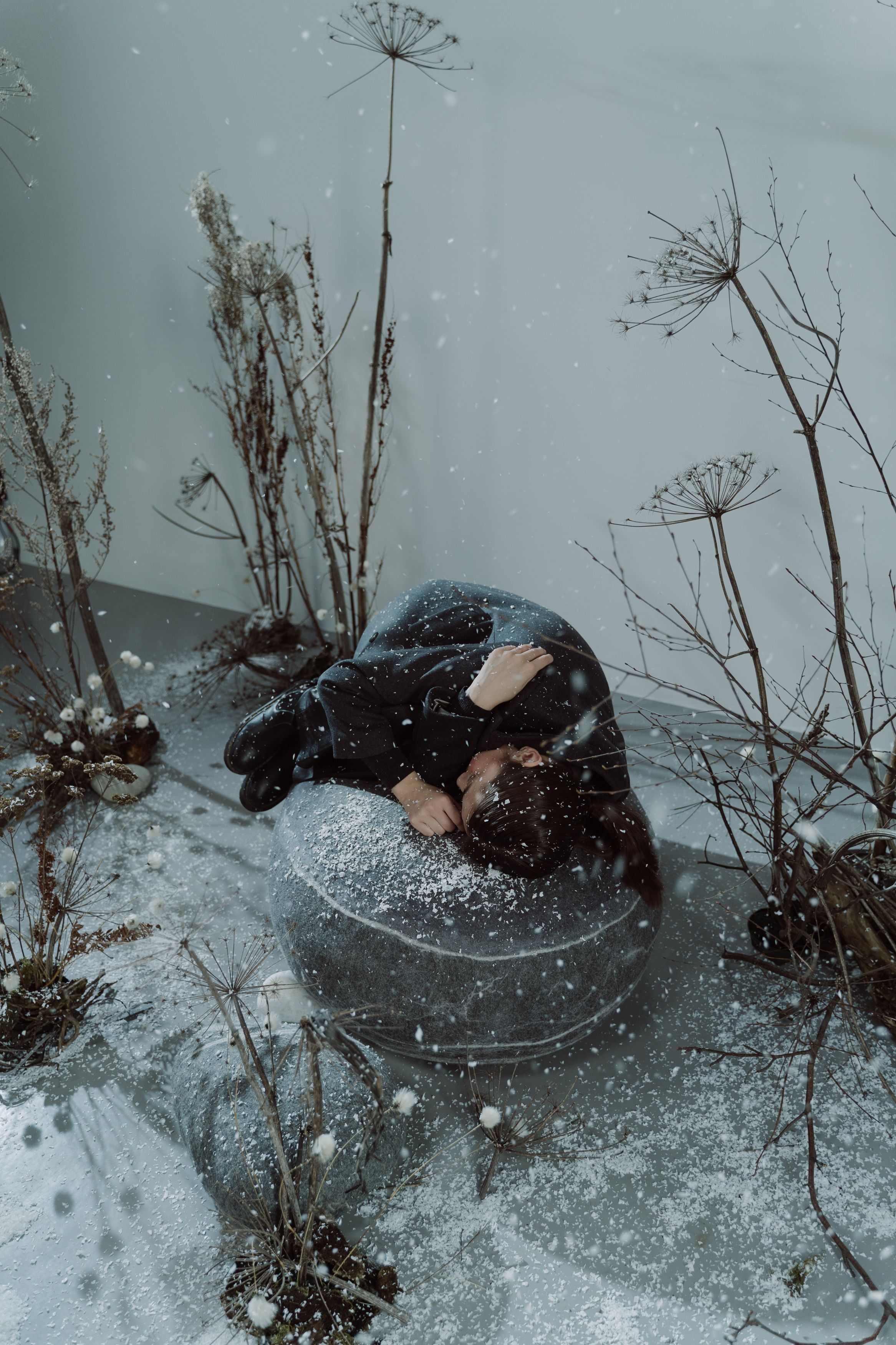Person Feeling Cold while Lying on a Round Rock · Free Stock Photo