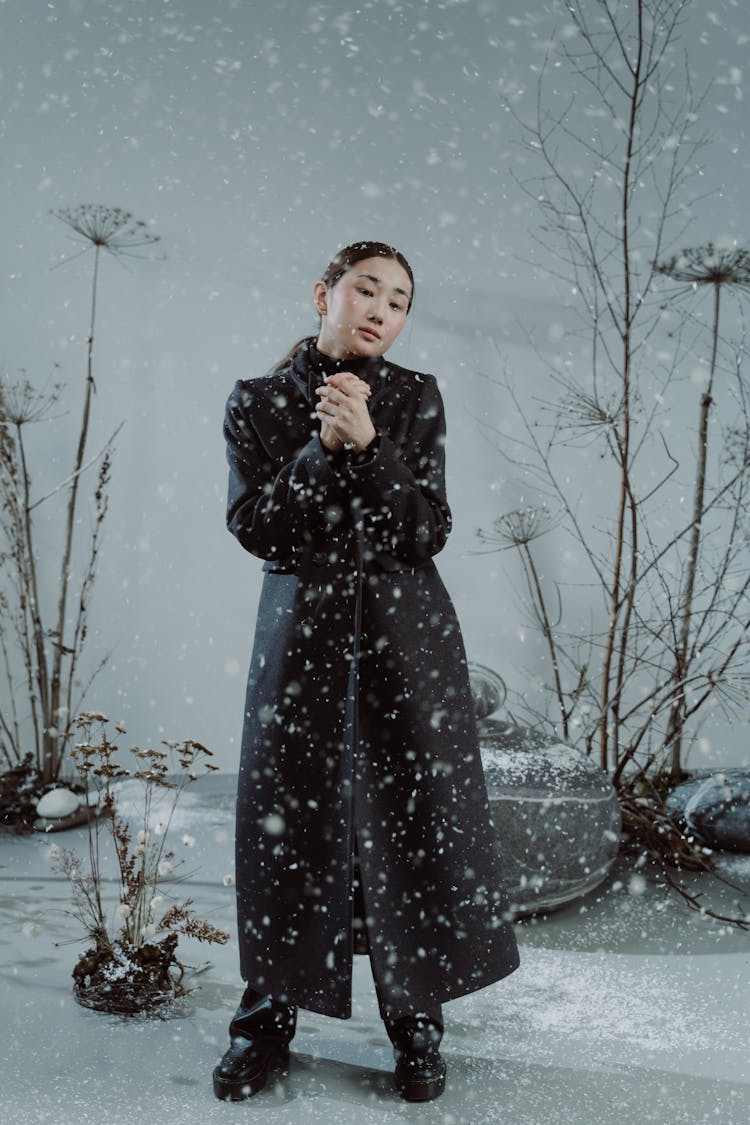 Woman In Black Coat With Snow Fall