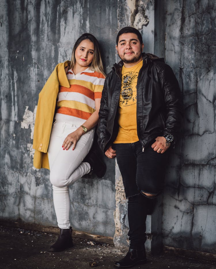 Man And Woman Posing On Ugly Wall 