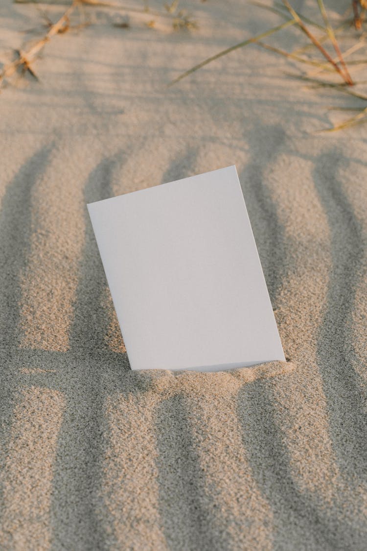 An Empty Card On The Sand 