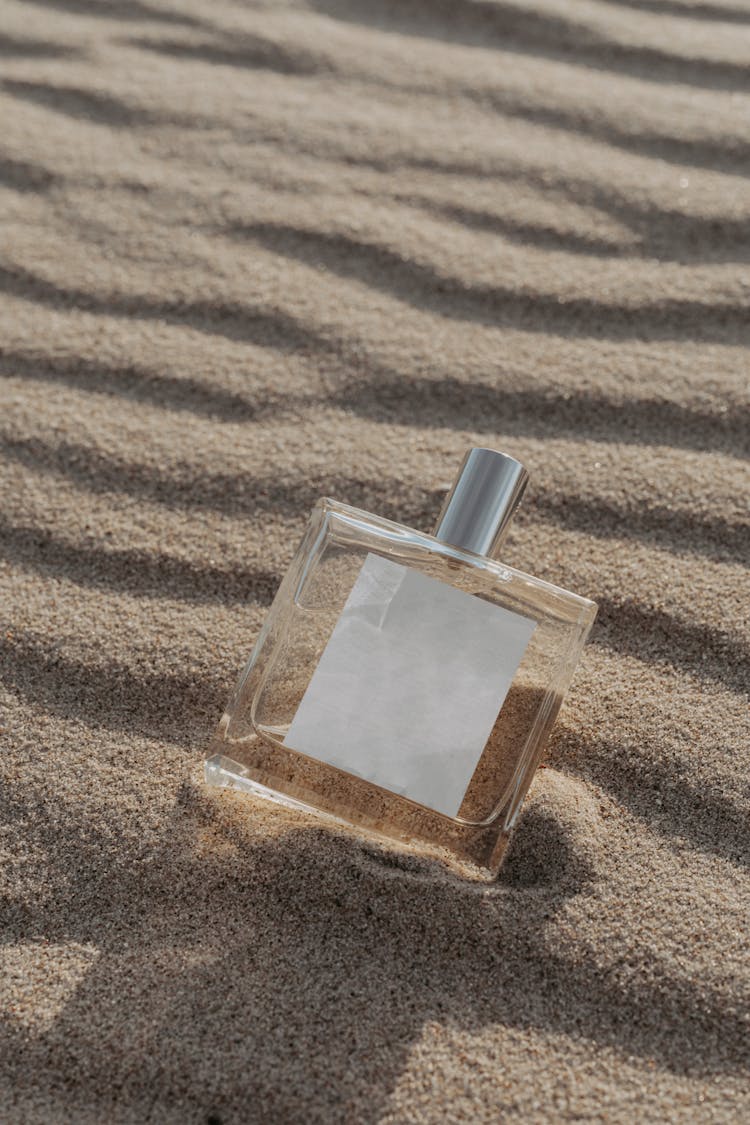 Square Glass Perfume Bottle On White Sand