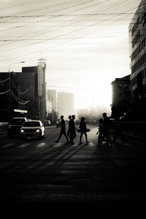 Free Grayscale Photo of People Crossing the Street in a City Stock Photo