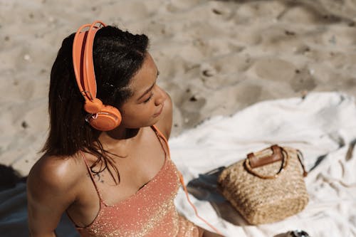 Free A Woman in a Swimsuit Listening to Music Stock Photo