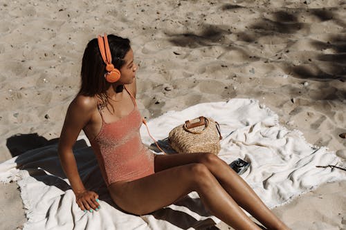 Free 
A Woman in a Swimsuit Listening to Music Stock Photo