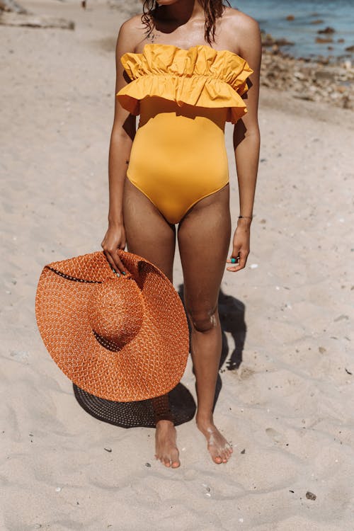 Woman in Yellow Bikini Standing on Beach