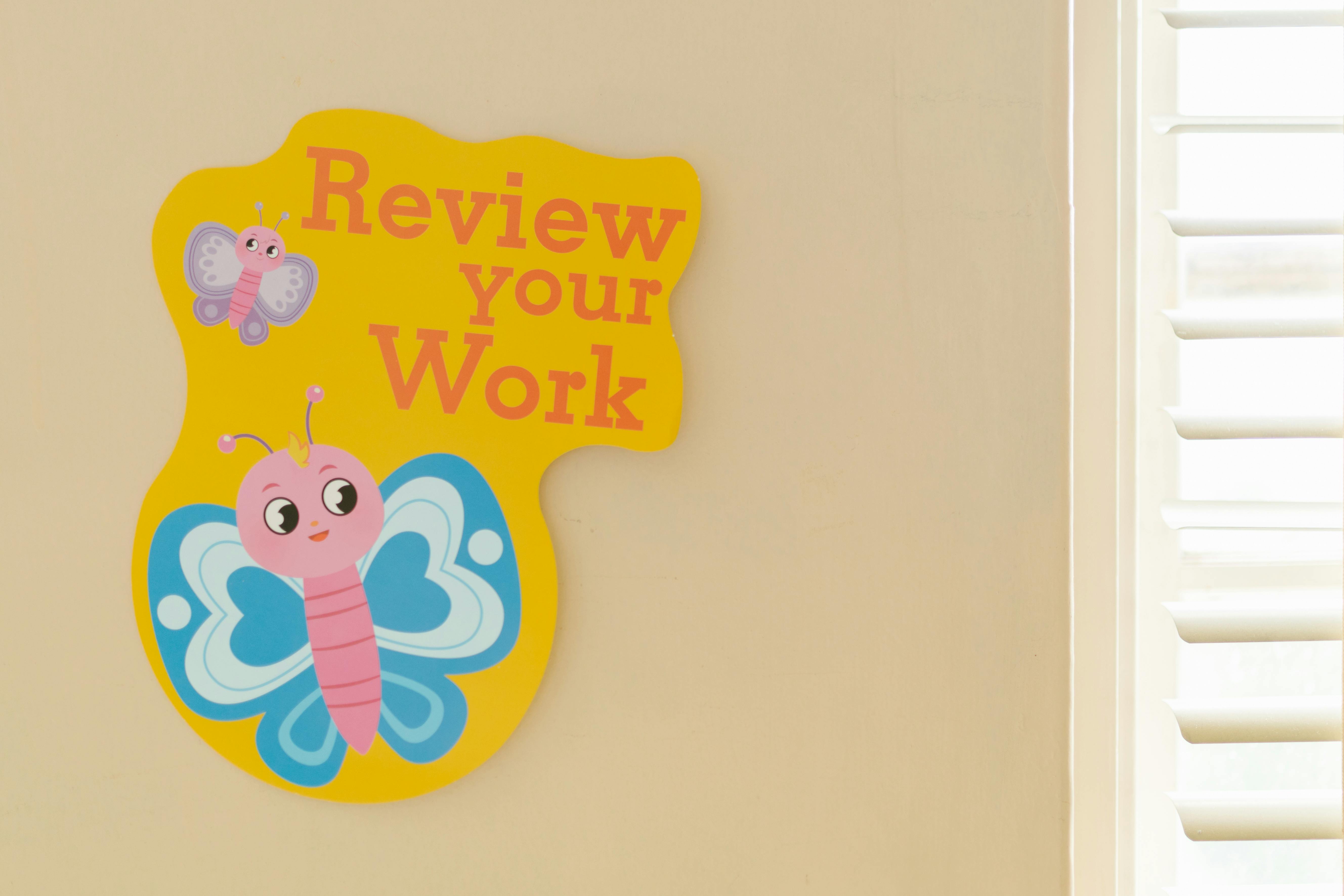 Cheerful butterfly-themed poster encouraging students to review their work.