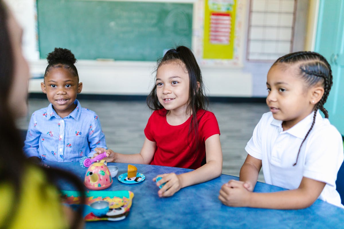 Children playing with childcare provider