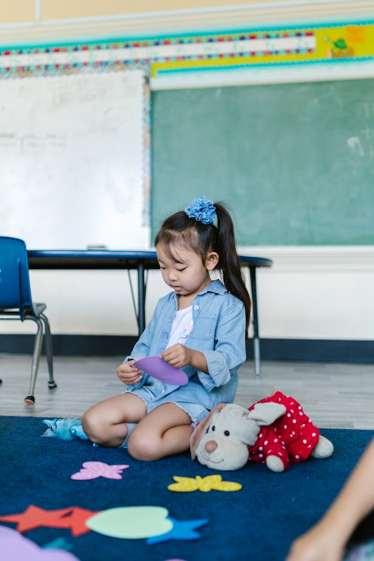 A Girl Playing With Toys At The School