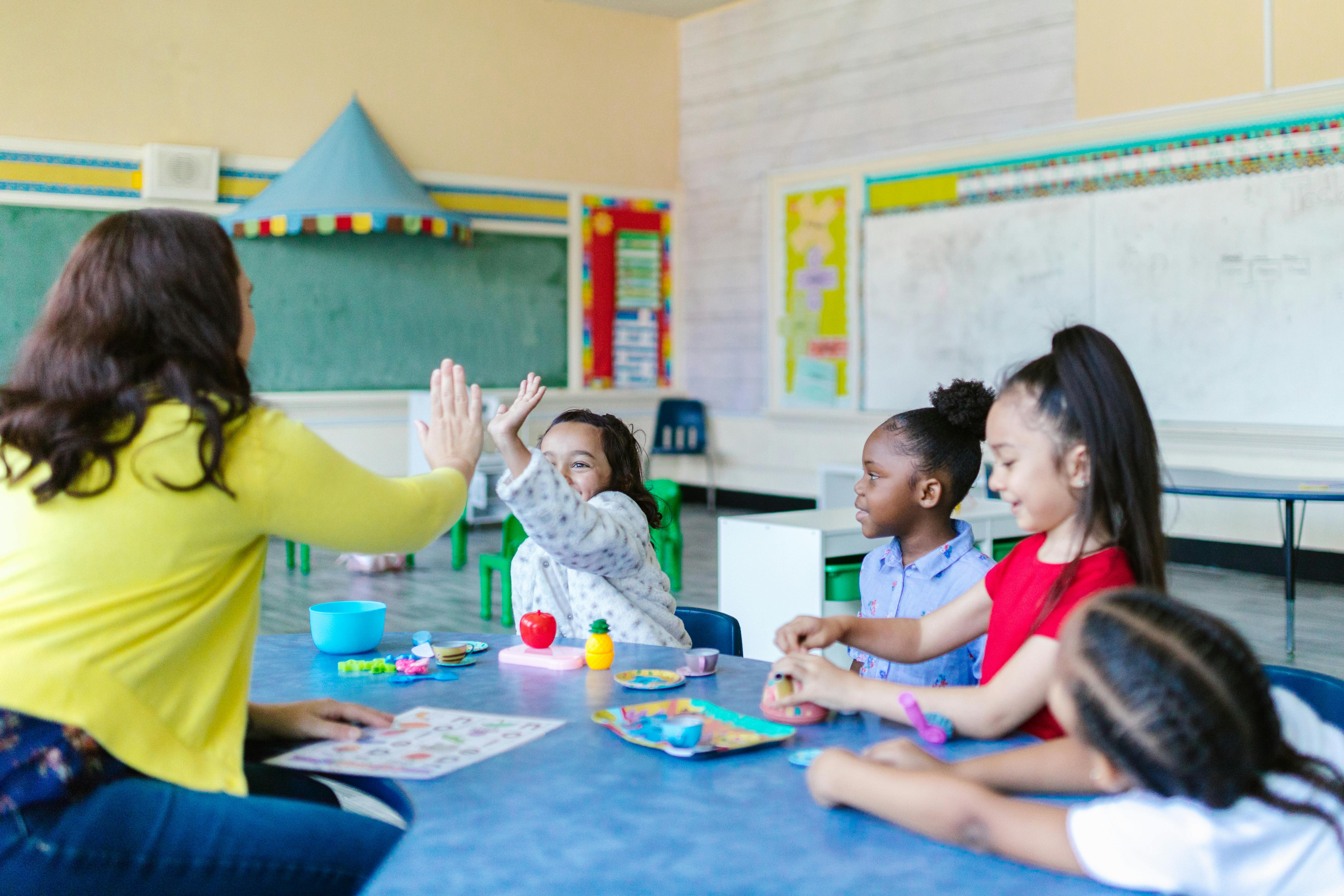 kids playing with teacher in the classroom