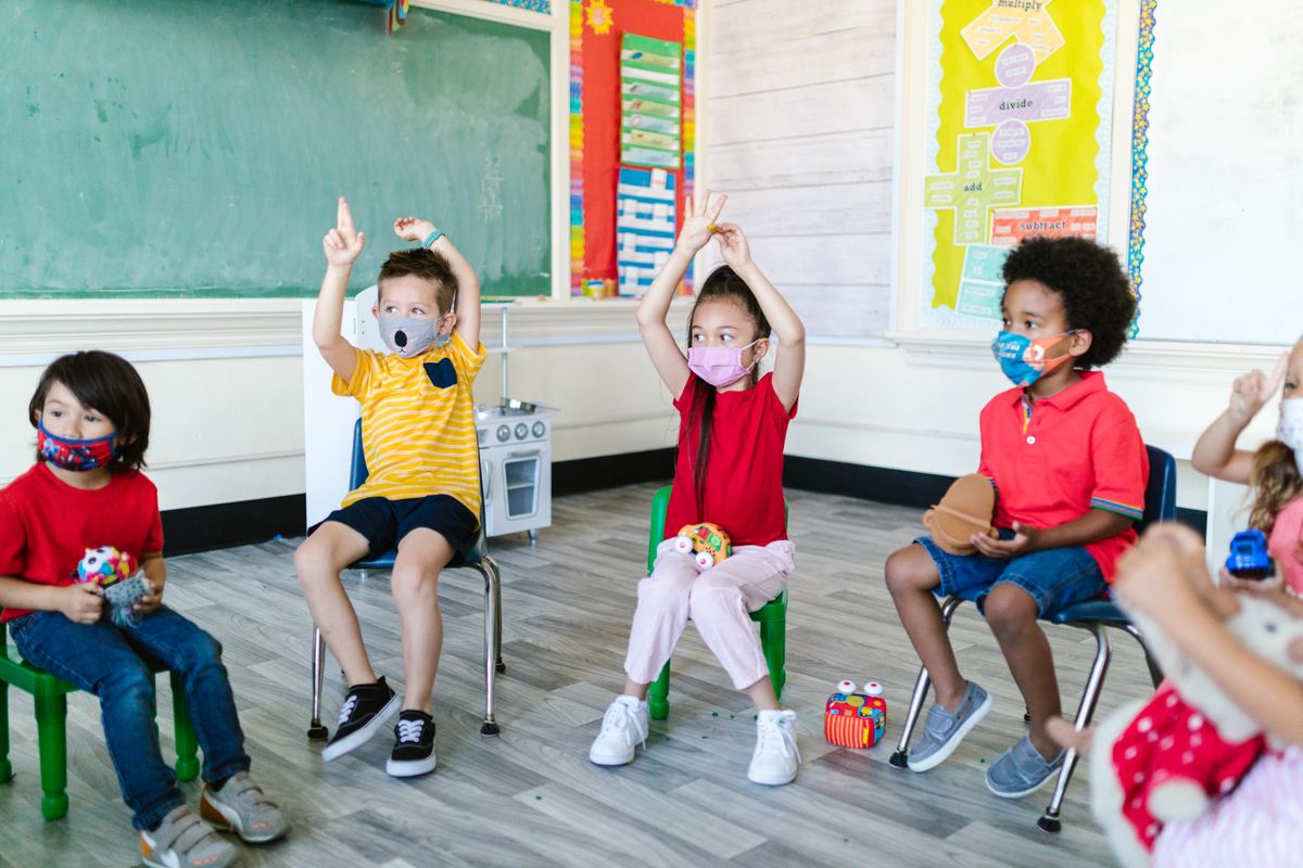 Kindergarten students sitting on their chairs in a classroom