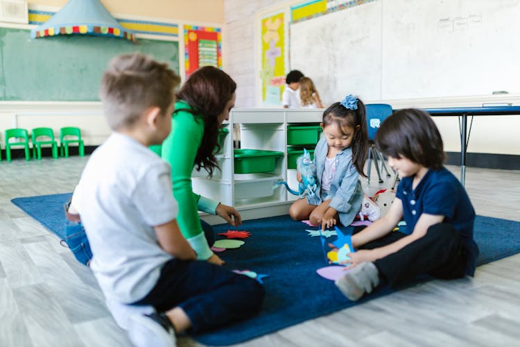 Children Sitting On A Carpet