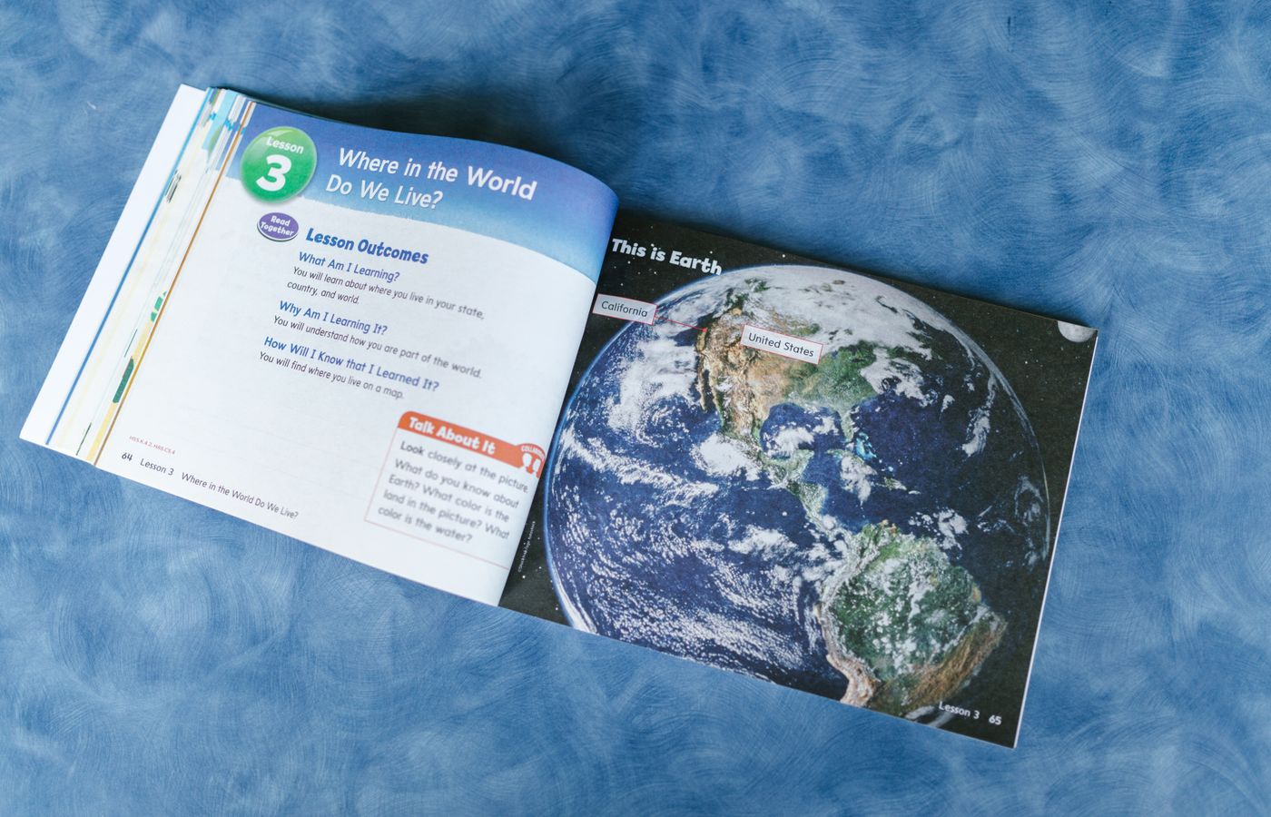 An open educational book displaying a world map and lesson outcomes about global locations.