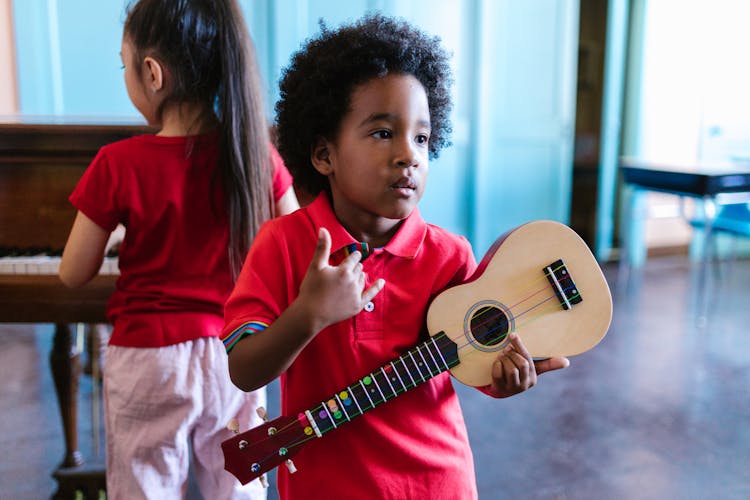 Boy Holding A Ukulele