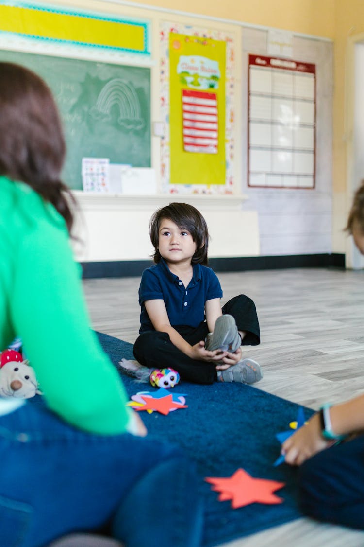 A Girl Inside A Classroom Listening To The Teacher