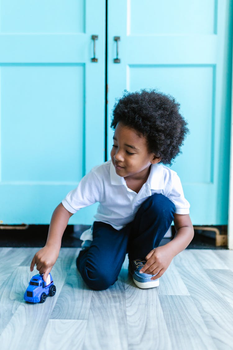 Child Playing With Toy Truck