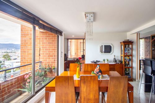 Free Bright dining room with modern decor and city view through large windows. Stock Photo