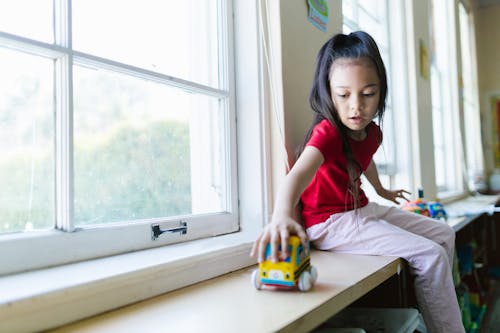 Free A Girl Playing with Toys in School Stock Photo