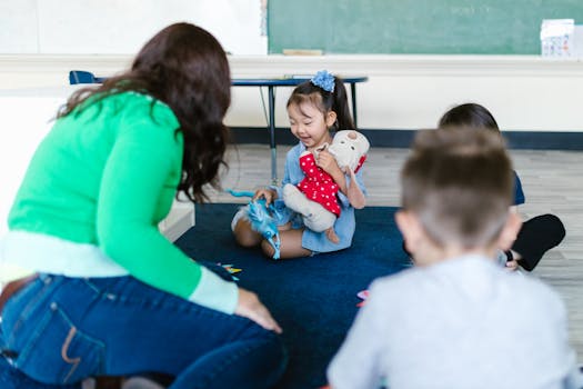 Group of children and a teacher engaged in a fun learning activity inside a classroom.