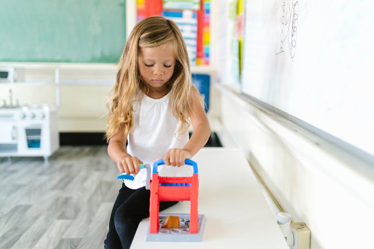 Girl Playing Toy In Classroom